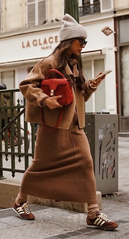 Уличный образ: женщина в коричневом трикотажном комплекте и аксессуарах, оттенки тёплого коричневого в городской среде, динамика и фактура.