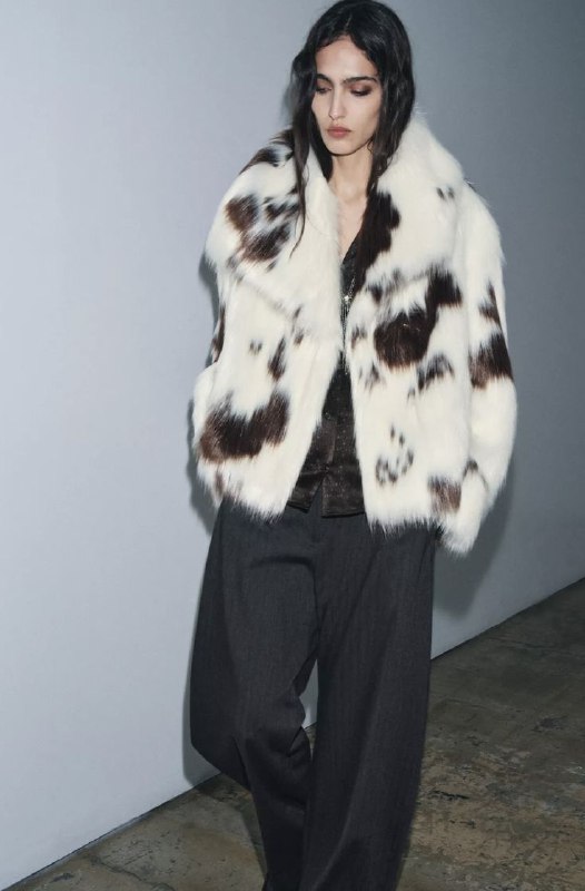 Белая шуба с коричневыми пятнами — контрастная цветовая фактура, свободный крой и акцент на рисунке меха в городской съёмке.