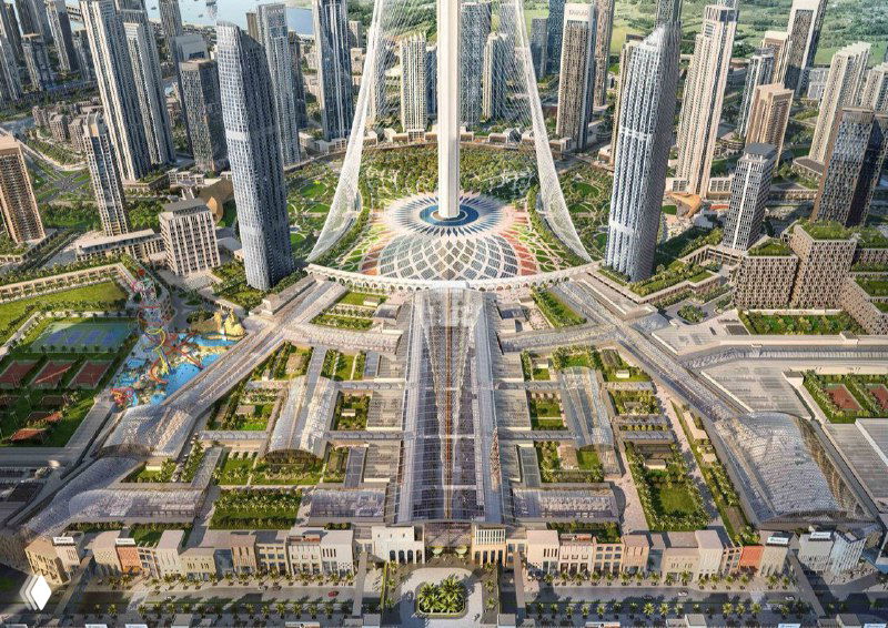 Вид сверху на макет проекта торгового центра и прилегающей инфраструктуры: центральная площадь, транспортные коридоры и соседние высотные здания.