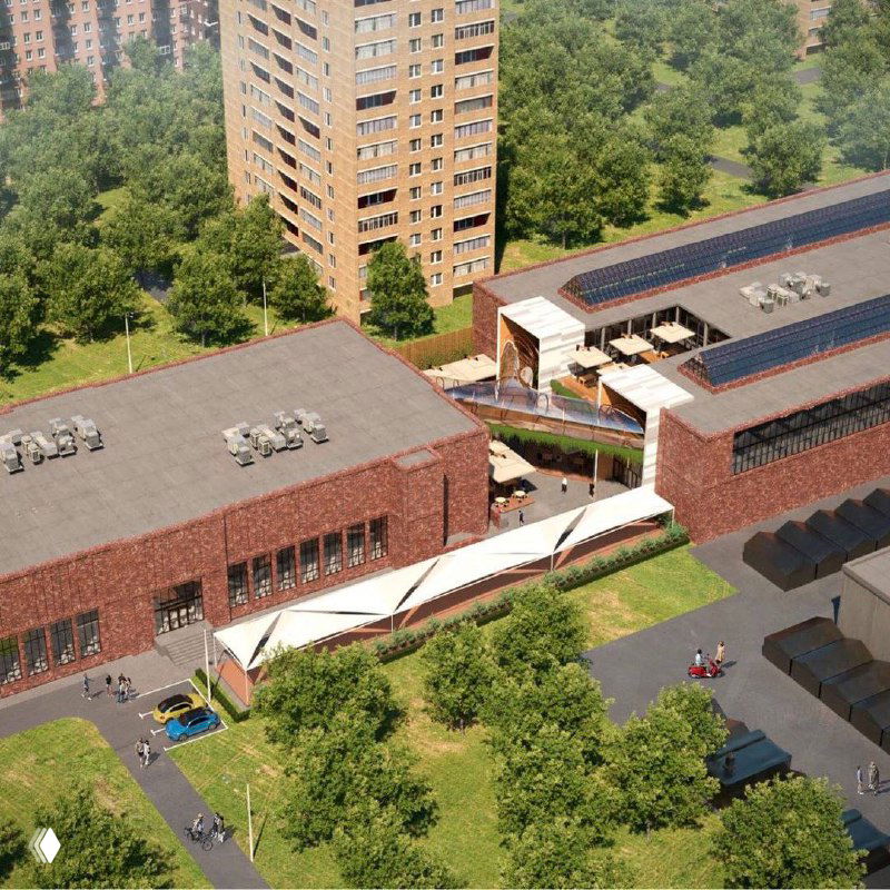 Аэросъёмка планируемого участка: общественно‑деловой корпус между жилыми домами, зелёные зоны и внутриквартальные связи видны сверху.