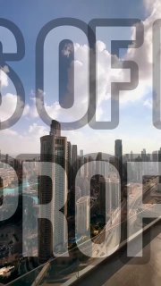 Apartment balcony view over a dense skyline with multiple high-rise towers and hazy sky; large semi-transparent text overlay suggests real-estate context.