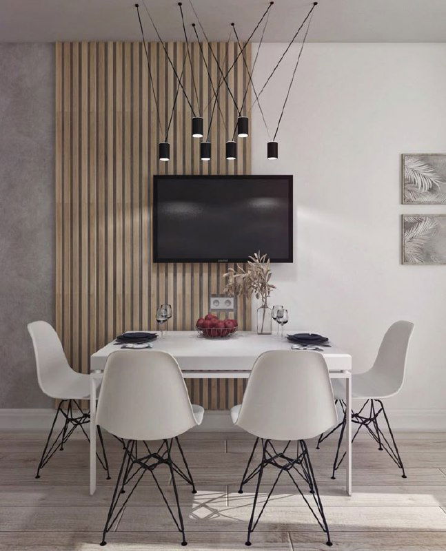 Обеденная зона со стеной, украшенной вертикальными панелями за телевизором, светлая мебель и современные подвесные светильники — гармоничный интерьер.