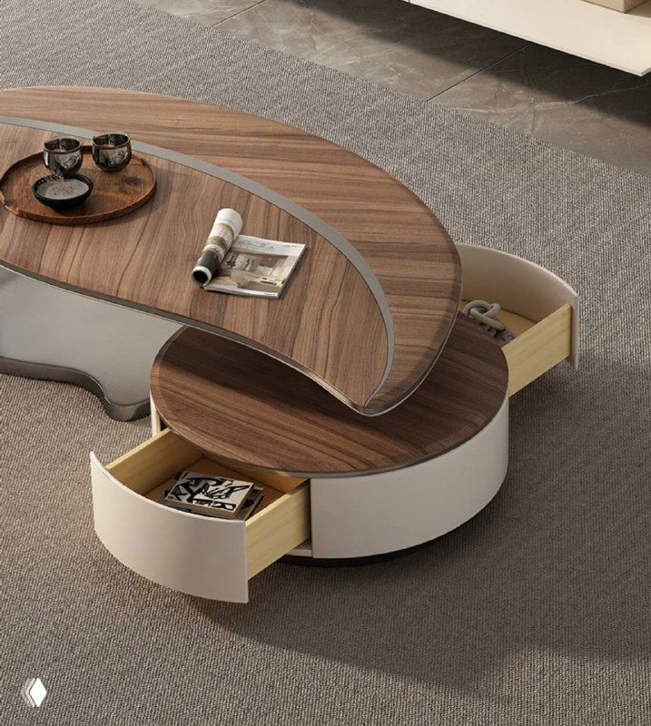 Крупный план журнального столика: деревянная текстура ясеня сверху и выдвижные секции в круглой основе из светлого материала.