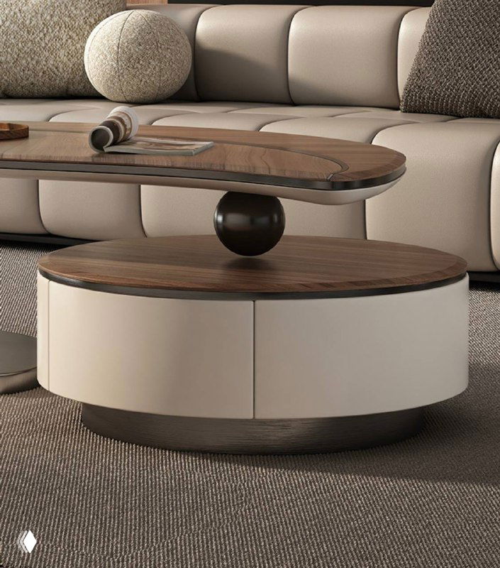 Ближний план журнального столика: сочетание круглой формы, деревянной столешницы и матовой светлой основы с выдвижным ящиком.
