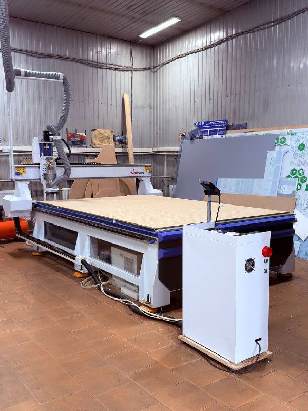 Большой ЧПУ‑станок с рабочим столом и заготовками — зона фрезеровки и раскроя материалов для корпусов домофонов.