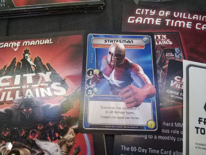 Крупный план карточки персонажа и мануала City of Villains: видна карточка Statesman и сопроводительные тексты/иллюстрации из набора.
