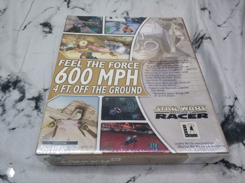 Задняя сторона коробки Star Wars Racer в заводской плёнке с крупным слоганом «FEEL THE FORCE 600 MPH», мини-скриншотами и описанием, фотография для документирования выпуска в коллекции.