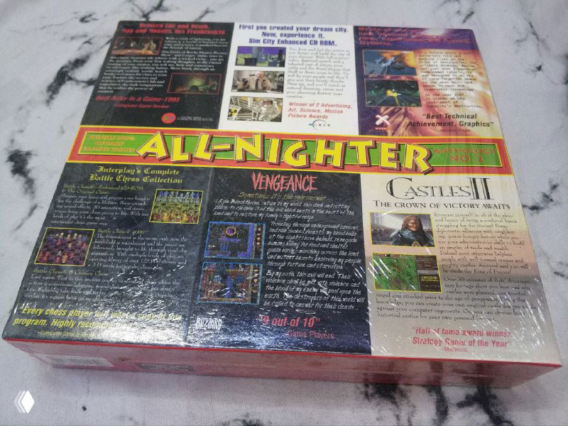 Фото тыльной стороны коробки All‑Nighter Interplay Anthology no.2 в пленке с описанием и скриншотами, коробка лежит на фоне стола