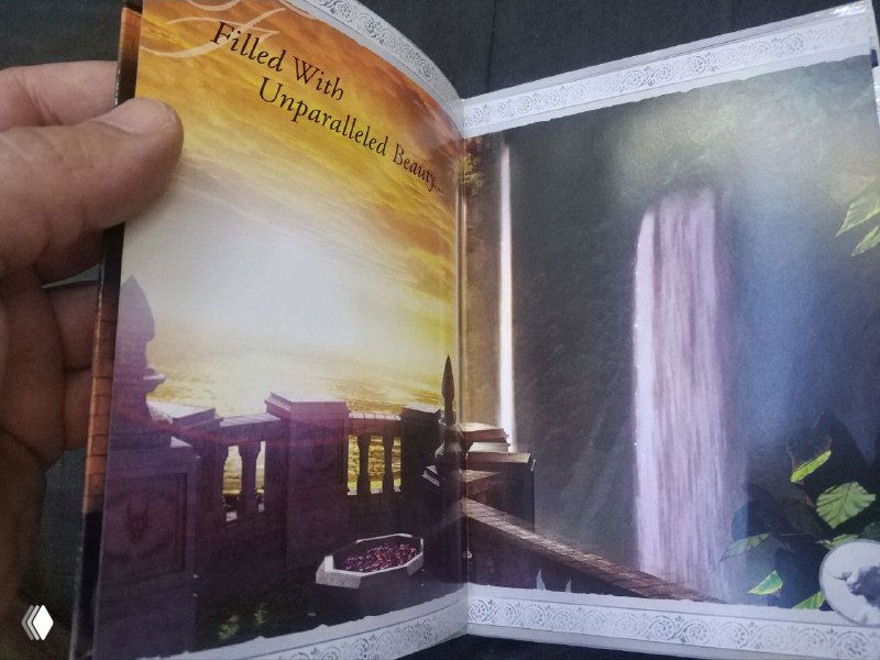 Страница с водопадом и архитектурой — глянцевая иллюстрация из разворота, демонстрируется фактура бумаги и насыщенные цвета.