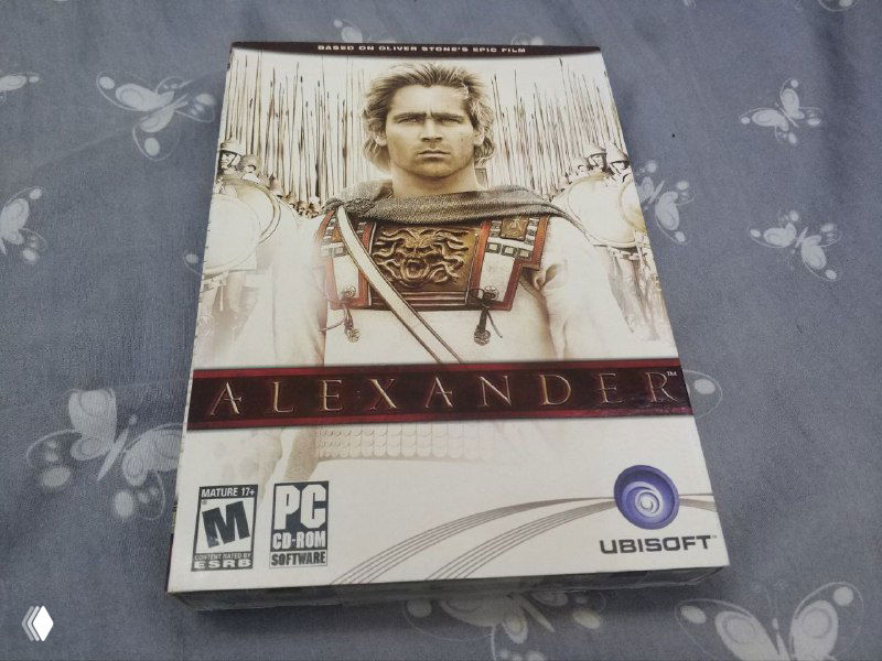 Передняя сторона бокса Alexander (Ubisoft) для PC с изображением персонажа из фильма, заметны логотип Ubisoft, возрастной рейтинг и оформление диска.
