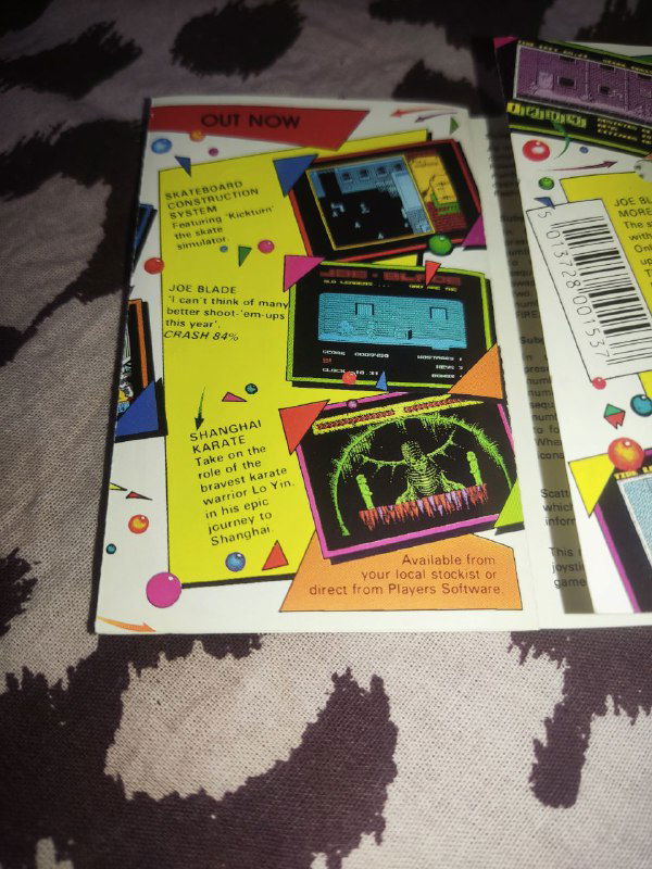 Крупный план рекламной вставки буклета Joe Blade II: жёлтый блок с заголовком 'Out Now', маленькие скриншоты игры и поясняющий текст — типичная реклама эпохи.