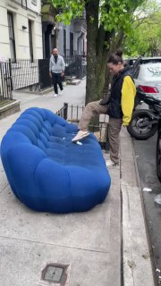 Уличная фотография: синий диван стоит на тротуаре Нью-Йорка, рядом девушка и прохожие, что иллюстрирует находку и уличный контекст истории.