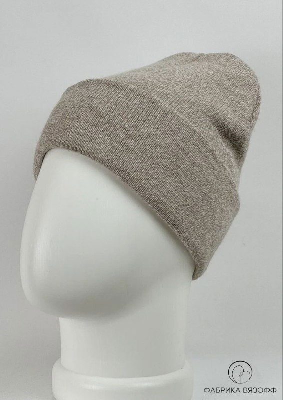 Светло‑бежевая базовая шапка на белом манекене, студийная фотография показывает плотность полотна и аккуратный отворот изделия.