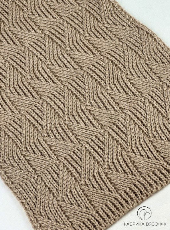 Фрагмент плотного вязального полотна бежевого цвета с геометрическим рельефным рисунком, видно регулярность и аккуратность петель.