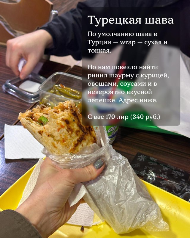 Хенд-хэлд: турецкая шава в тонком лаваше, видно начинку с курицей и овощами — снимок у стойки фастфуда в Анталии.
