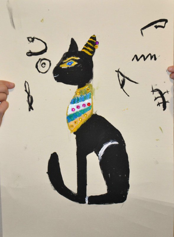 Картина кошки в образе богини Бастет на фоне нарисованных иероглифов; выполнено черной краской с золотыми и цветными акцентами.