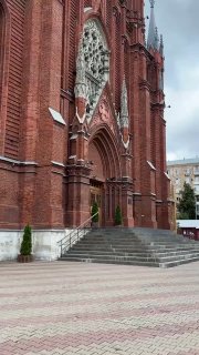 Общий вид Кафедрального Собора Непорочного Зачатия и площадь перед ним: неоготическая композиция фасада и окружающая городская среда в Москве.