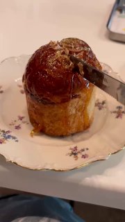 Крупный план процесса разбивания хрустящей карамельной шапки кулича: видна текстура карамели и мякиша внутри.