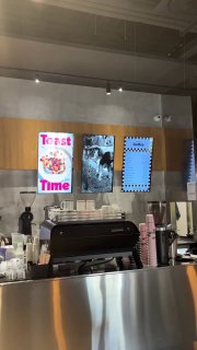 Барная стойка и кофейный автомат внутри Rebellion; вид на кафе со стороны выдачи заказов и элементов оформления кассы и меню.