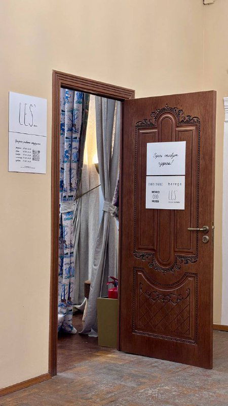 Резная деревянная дверь с панелями и открытым проходом в зал за тканевыми портьерами, вид на оформление интерьера усадьбы Гардеева‑Грачева.