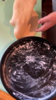 Раскатывание теста вручную на рабочей поверхности: толстые листы песочного теста, видна посыпка мукой на форме.