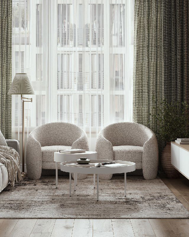 Уютная зона с двумя округлыми креслами у окна, текстурными шторами, небольшим кофейным столиком и мягким винтажным ковром в интерьере.