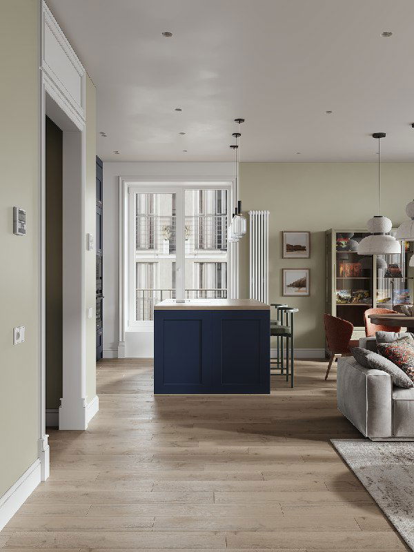 Общий вид кухни-гостиной: темно-синий остров в центре, мягкая зона гостиной справа, большие окна и естественный свет в пространстве.