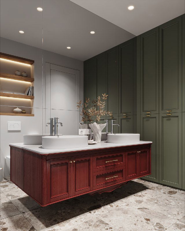 Крупный план подвесной тумбы винного оттенка у зеркальной стены, две настенные раковины и декоративная ваза с сухоцветами на столешнице.