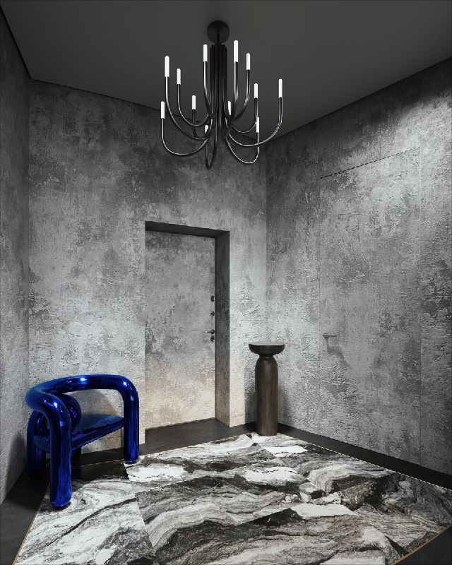Интерьер прихожей в тёмных тонах с синим стулом и большой мраморной зоной на полу; грубая штукатурка на стенах и современная люстра завершают образ.