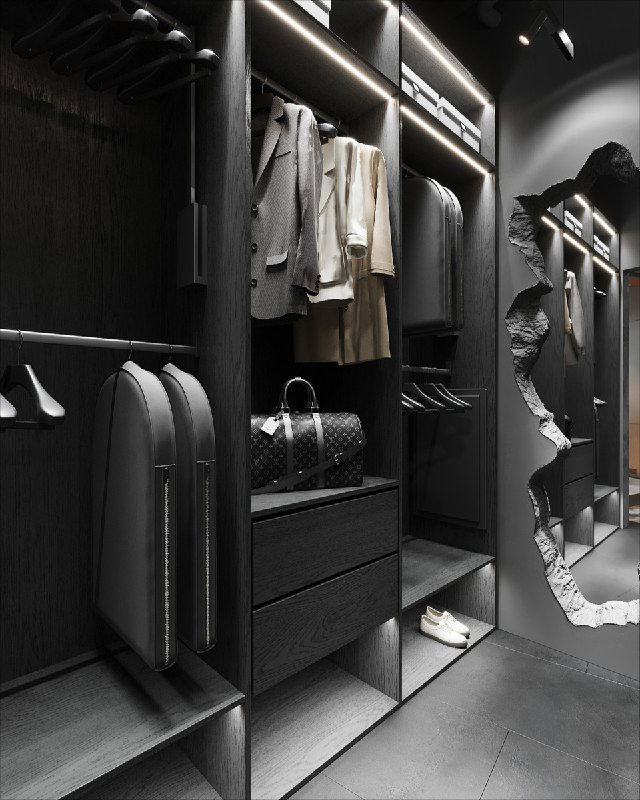 Интерьер гардеробной с чёрными полками, развешенной одеждой и точечной подсветкой, подчёркивающей текстуру отделки.