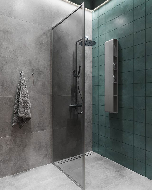 Душевая зона с прозрачной стеклянной перегородкой, серыми плитками и зелёными настенными панелями; вид на душ и настенные смесители в лаконичном стиле.