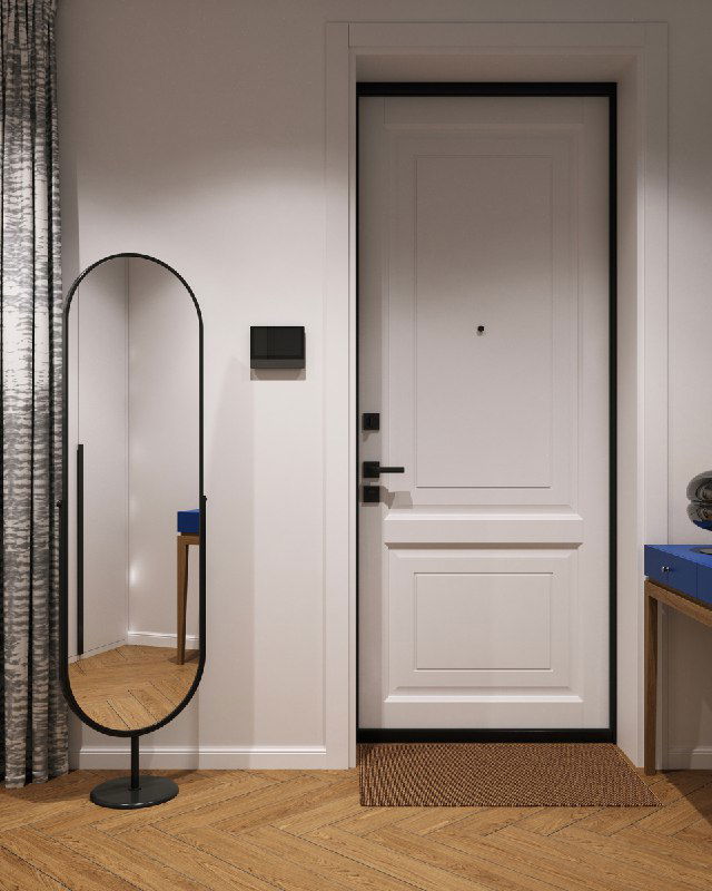 Входная зона с белой дверью, ковриком и овальным напольным зеркалом; слева видна штора, заменяющая межкомнатную перегородку.