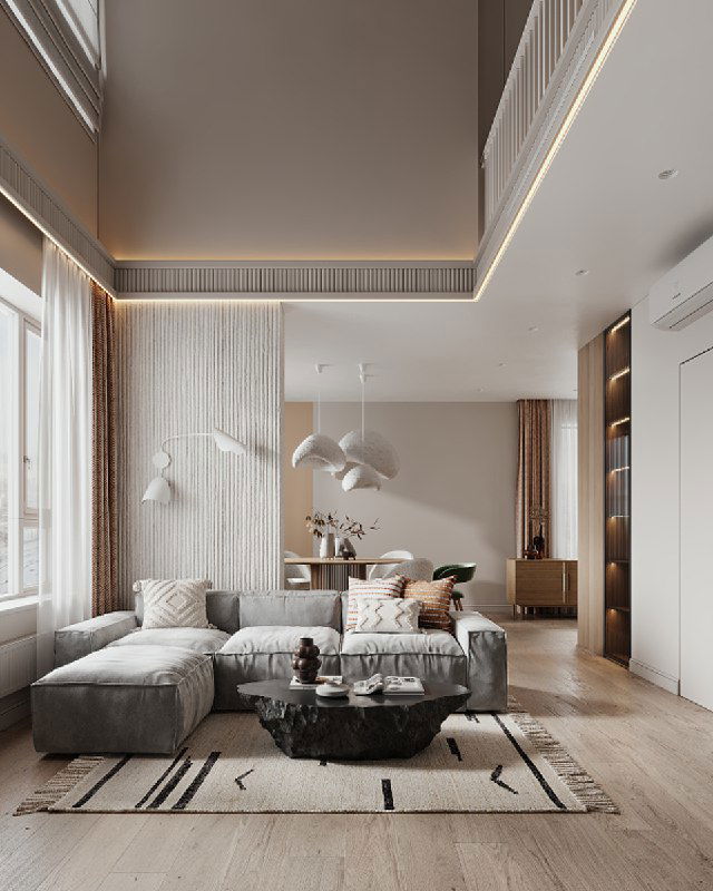 Общий вид просторной гостиной с высоким потолком, мягким диваном и столиком-скалой в центре, нейтральная палитра и текстуры.