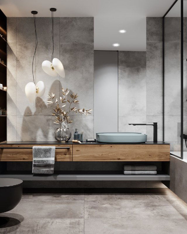 Ванная комната мастер‑спальни в современном стиле: плитка под бетон, деревянная столешница, подвесная раковина и декоративные светильники над рабочей зоной.