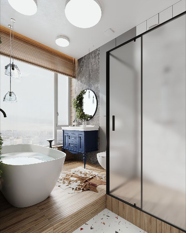 Ванная с панорамным окном, отдельно стоящая ванна, синяя тумба у окна и стеклянная душевая перегородка.