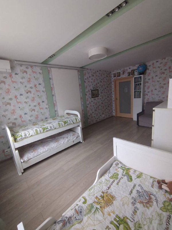 Детская комната после перекраски стен и перестановки мебели: светлый пол, кровати и нейтральный декор для широкой аудитории покупателей.