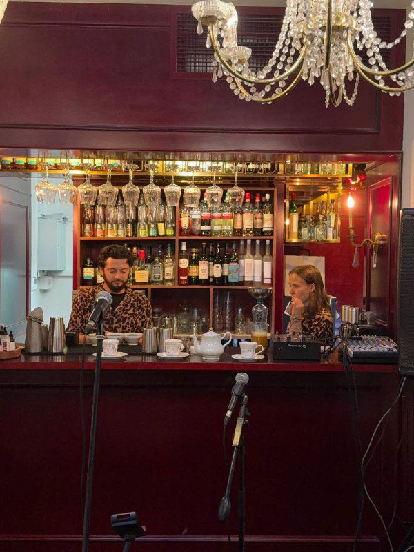 Барная зона Mia Strada с полками бутылок, барменом и подсветкой — акцент на напитках и обслуживании внутри ресторана.