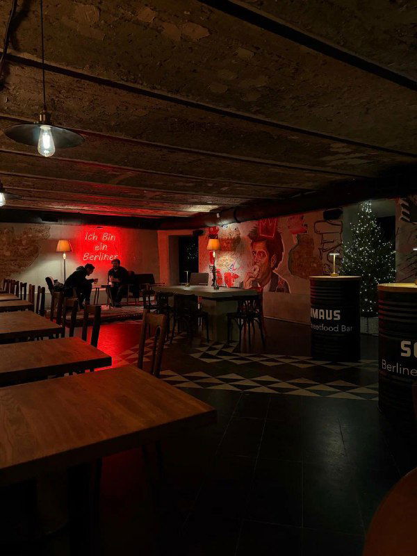 Интерьер стритфуд-бара с сценой, яркими граффити на стенах и простыми столами — место для живой музыки и вечерних тусовок.