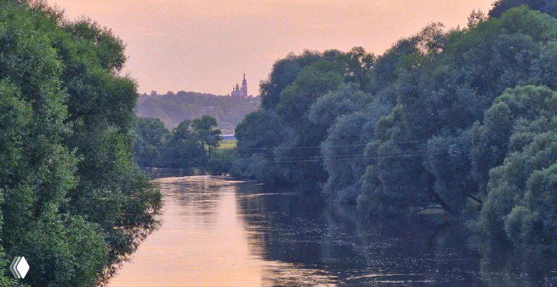 Река Протва в тёплых тонах заката, зеркальная поверхность воды и силуэты деревьев, спокойная вечерняя атмосфера.
