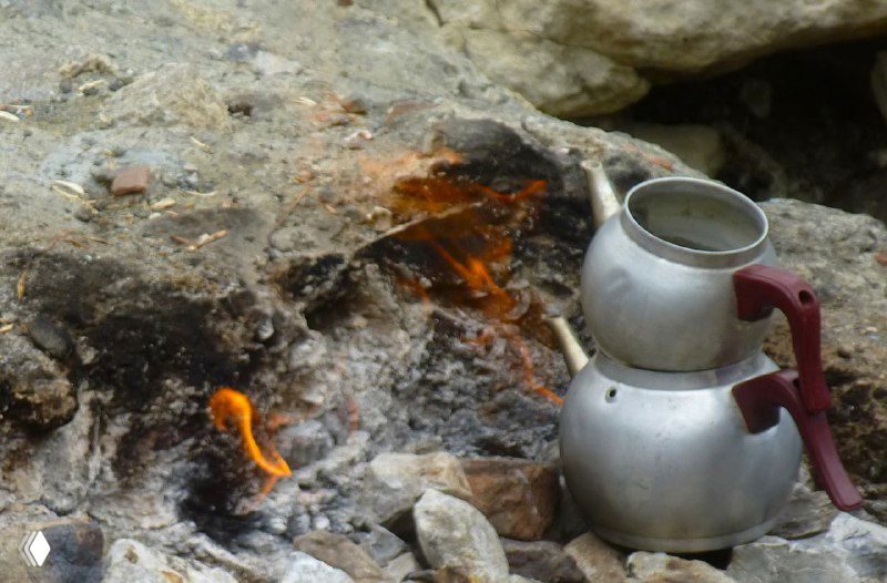 Чайник (турка) на камнях рядом с небольшим огнём, люди пользуются природными огнями Химеры для подогрева и приготовления пищи.