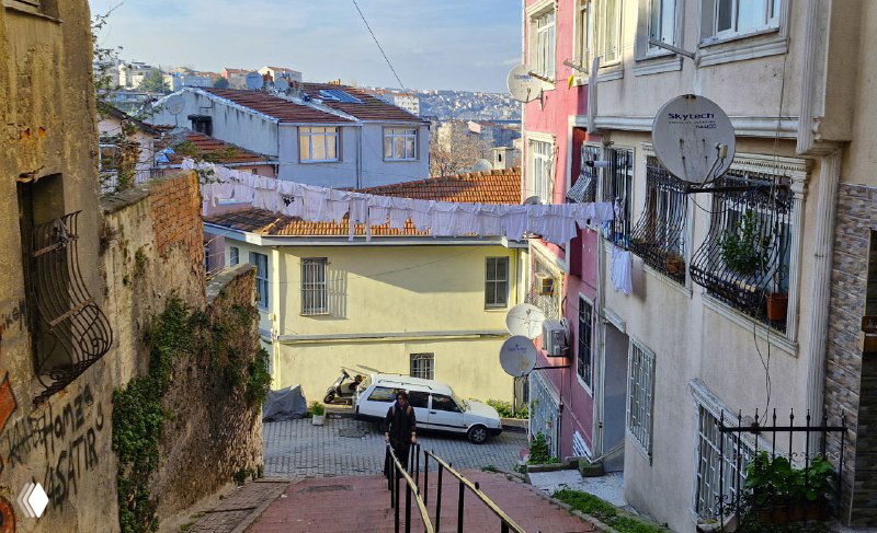 Вид со ступеней в сторону жилых кварталов Балата: узкие проезды, припаркованные автомобили и разноцветные фасады