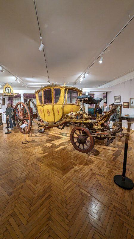 Экспонаты музея в Ярославле: старинная карета в зале с паркетом и витринами, культурная составляющая поездки автора на соревнование.