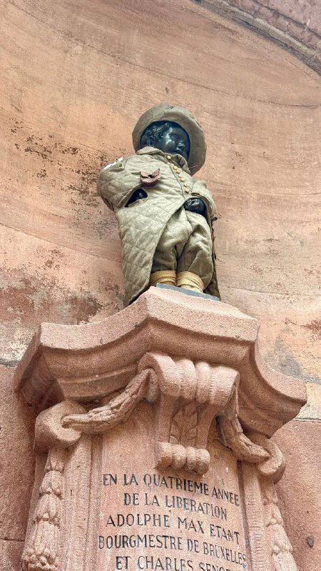 Фрагмент скульптуры на фасаде или нише с фигурой в камне, архитектурная деталь исторического здания Кольмара.