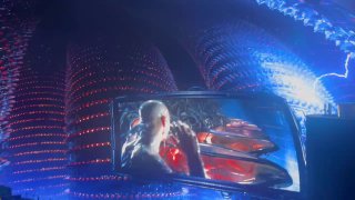 Фрагмент фильма на изогнутом экране: сцена с героями и яркими спецэффектами, окружённая световыми элементами иммерсивного зала.