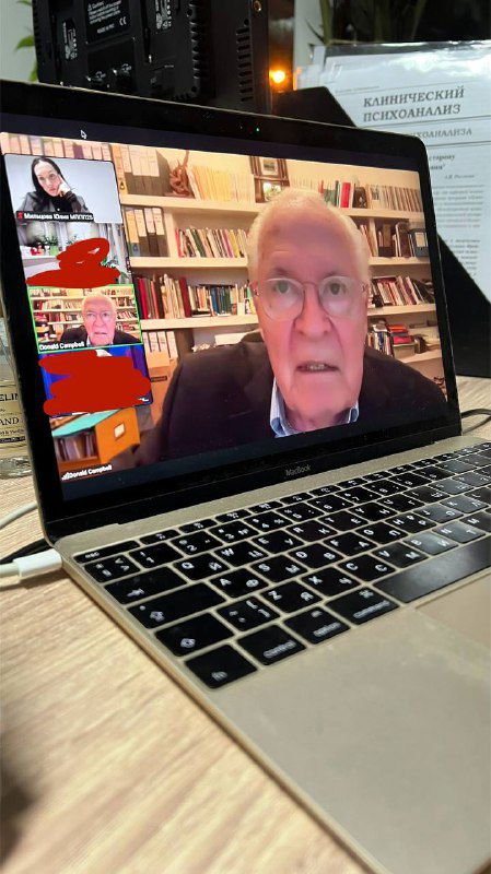 Экран ноутбука с трансляцией супервизии: лицо Дональда Кэмпбелла на видеозвонке, рядом рабочее пространство и документы.