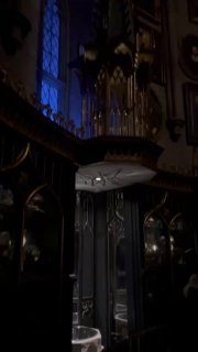 Тёмный интерьер с большим органом или декором из зоны Гарри Поттера; мистическая внутренняя сцена аттракциона в Universal Studios.