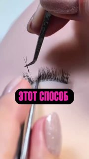 Крупный план процесса наращивания ресниц: пинцетом прикрепляют искусственную ресницу к натуральной, видна рука мастера и подпись на изображении.