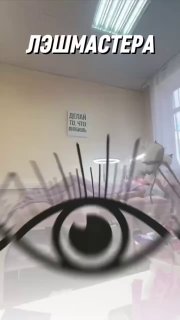 Интерьер учебного кабинета лэшмастера с крупной графической наклейкой глаза и надписью «лэшмастера», видны размытые рабочие инструменты и столы.