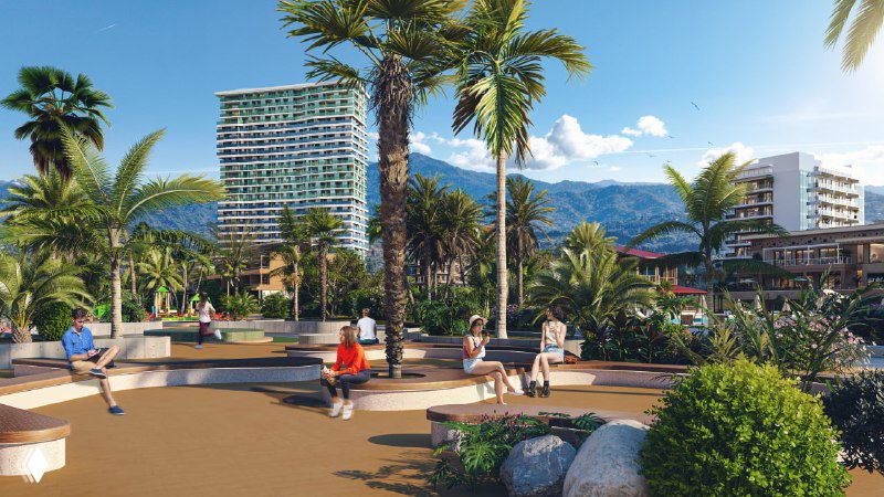 Общественное пространство комплекса: прогулочные зоны, пальмы и зелёные площади, люди отдыхают на благоустроенной территории первой линии.