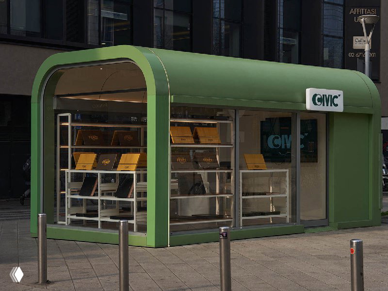 Зелёная современная киоскообразная конструкция с большими стёклами и внутренняя экспозиция книг и альбомов на полках — пример городской торговой точки книг.